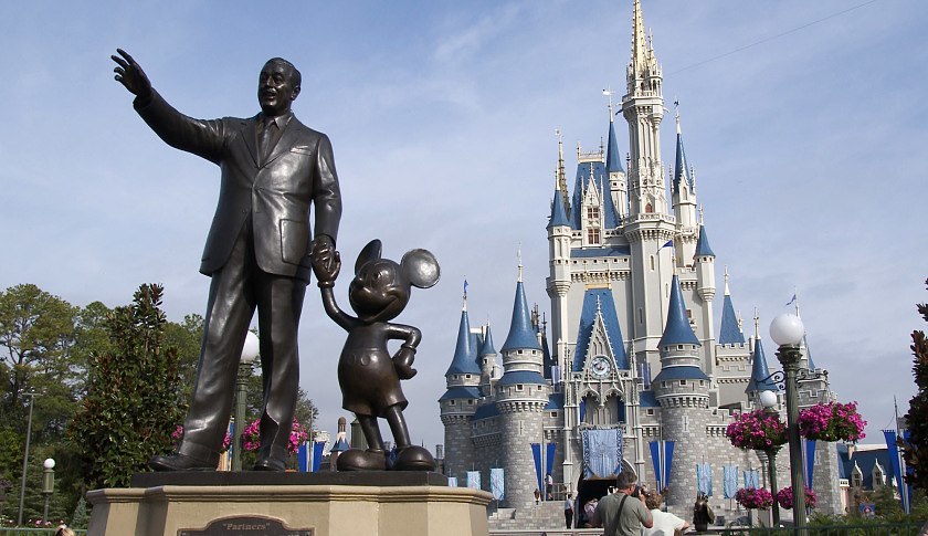 UNITED STATES - FEBRUARY 11: A statue of Walt Disney and Mickey Mouse stands in front of the Cinderella's castle at Walt Disney World's Magic Kingdom in Lake Buena Vista, Florida, Wednesday February 11, 2004. Growing attendance at the Walt Disney Co.'s theme parks and an increase in advertising sales at ESPN, ABC Family and the Disney Channel may help CEO Michael Eisner rebut claims that he's mismanaged Disney. (Photo by Matt Stroshane/Bloomberg via Getty Images)