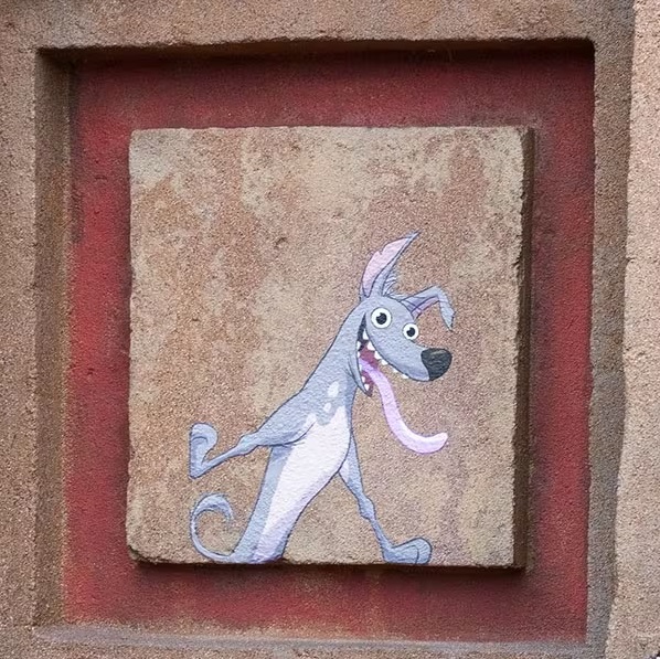 Un dessin à la craie d'un chien sur un mur.