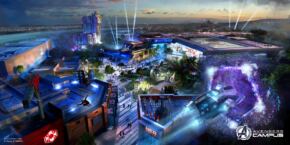 Vue aérienne du Campus Avengers à Disneyland, un rassemblement de bâtiments et d'attractions thématiques avec des éléments futuristes et de super-héros, entourés de verdure, de sentiers et d'un paysage urbain en arrière-plan.